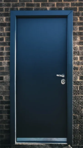 Solid bullet-resistant security door installed in a brick exterior wall
