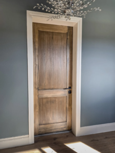 High-end wood vault room door designed to blend with the interior